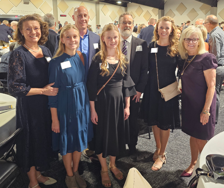 2 PRF President Michael Ramey with Senator Liz Brown (right) and Esther (far left) and her family at the IFI Fall Dinner October 6, 2025.